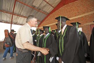 SAMARITAN’S PURSE PRESIDENT FRANKLIN GRAHAM VISITED WITH STUDENTS DURING THE SCHOOL’S FIRST GRADUATION.