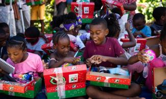 JOSHUA SCREAMED, “THIS IS THE BEST DAY EVER!” WHEN HE OPENED HIS SHOEBOX FULL OF GOODIES.