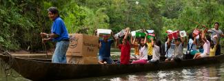 Children on a boat with shoebox gifts