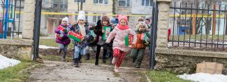 Children running with shoebox gifts