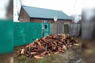 A large pile of firewood in front of Tetiana's house