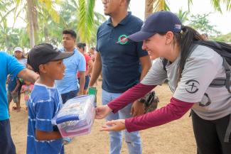 DART team member gifts a little boy at the outreach