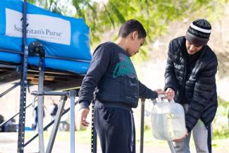 PEOPLE ARE GRATEFUL TO HAVE ACCESSIBLE DRINKING WATER AFTER THE DISASTER.