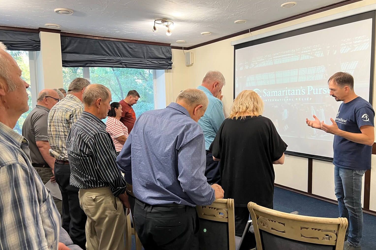 COMMUNITY REPRESENTATIVES JOINED IN PRAYER TO THANK GOD FOR PROVIDING WATER DURING THESE TUMULTUOUS TIMES.