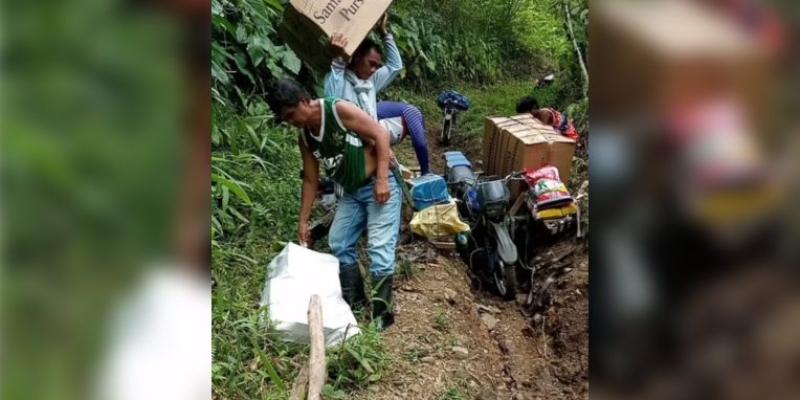 When the path became too difficult for the dirt bike, the team personally carried the cartons of shoeboxes the rest of the way to the village…