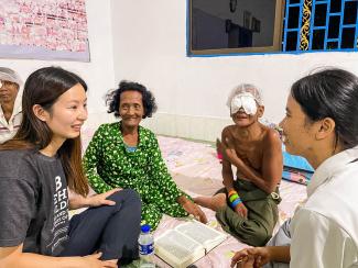 Sao and Mao listened as local Samaritan’s Purse staff shared their testimonies at the church. Although he couldn’t see, Sao’s heart began to soften to the Gospel.